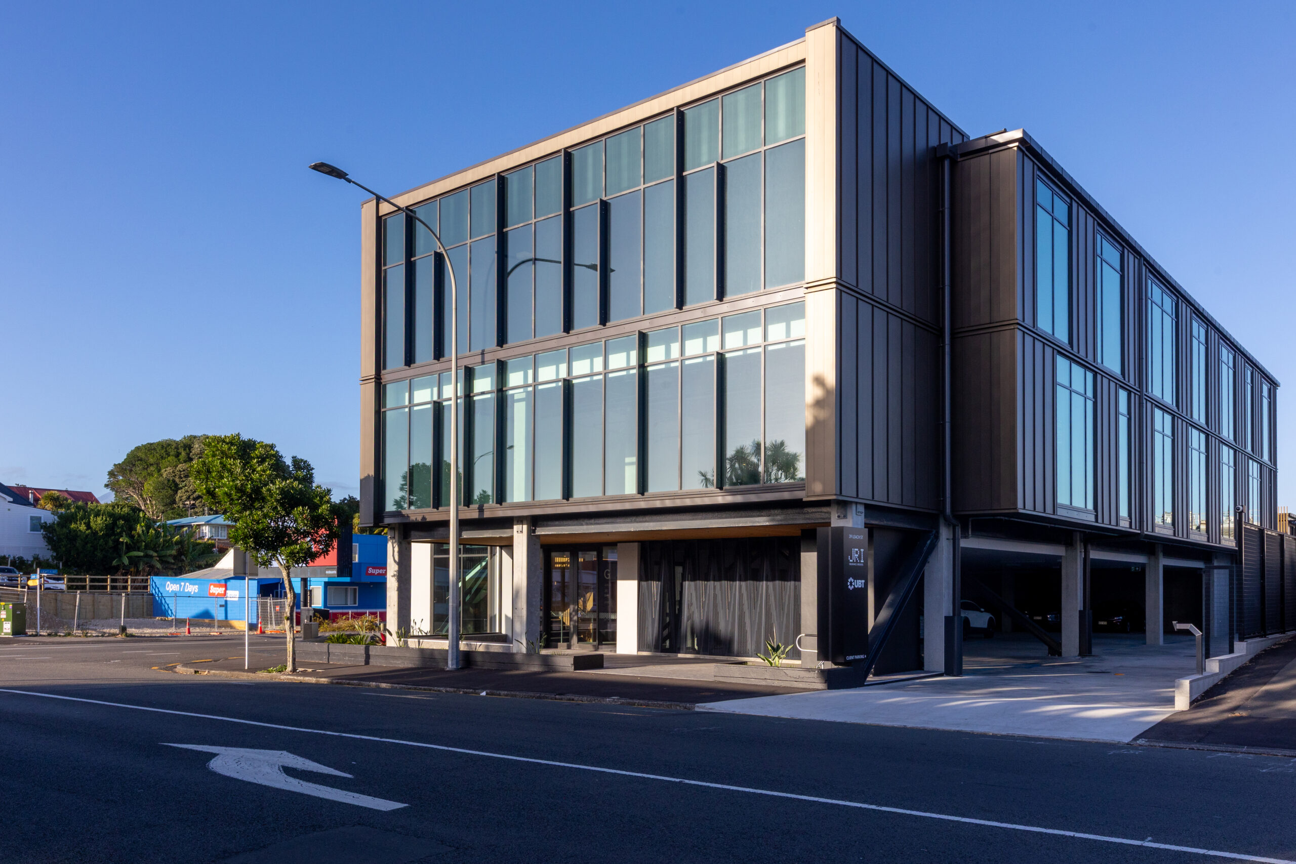 Exterior view of the completed JRI Office Building, a modern commercial construction project with a contemporary façade and professional finish.